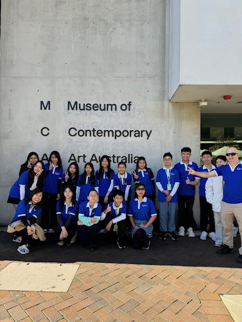 Study tour students in matching polo shirts outside the Museum of Contemporary Art Australia